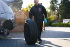 Rolling Rims technician moving a wheel beside a vehicle