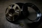 Dismantled split rim wheel with its centre, barrel and bolts