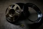 Dismantled split rim wheel with its centre, barrel and bolts