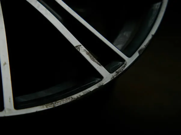 Damaged alloy wheel showing corrosion and cosmetic wear