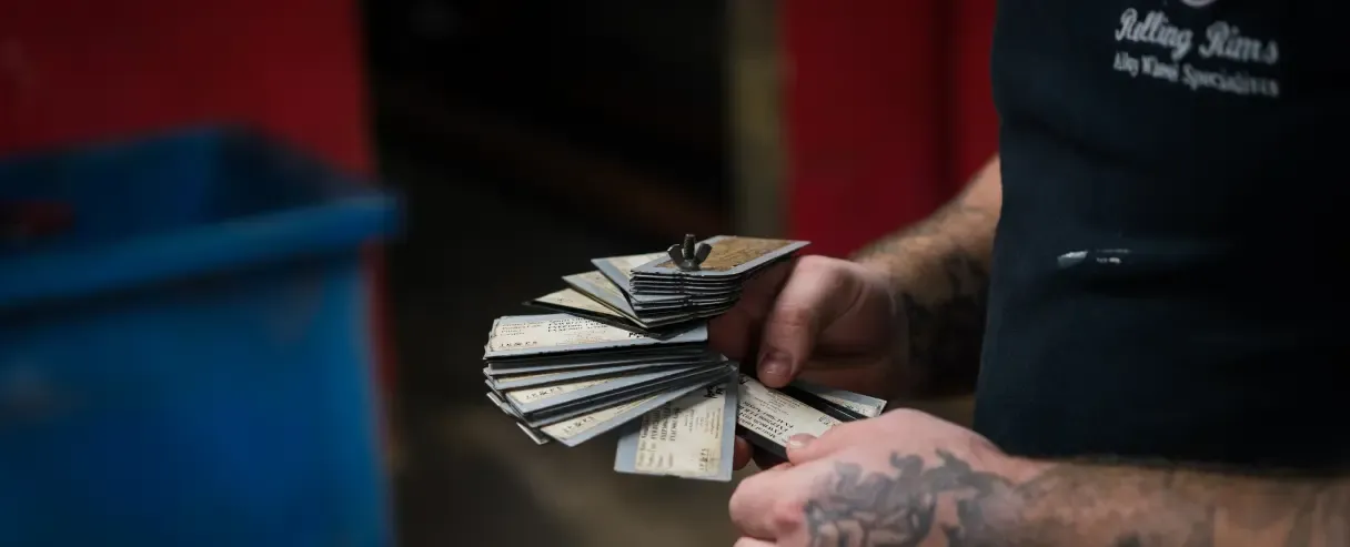 Rolling Rims employee checking the paint code of the matching colour coding cards