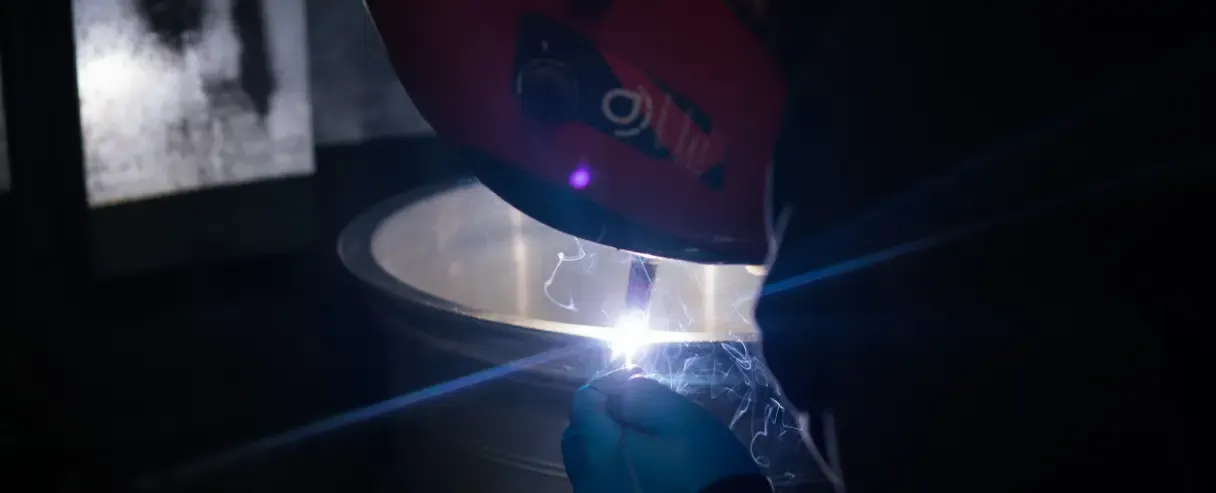 Close up of a cracked alloy wheel being welded by a Rolling Rims employee
