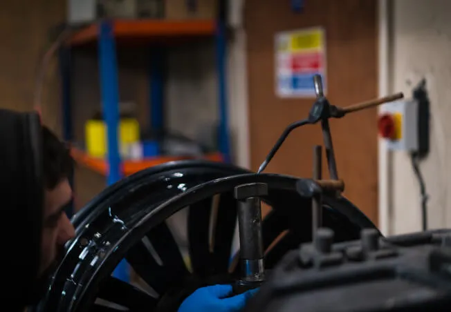 Buckled alloy wheel being straightened on Rolling Rims alloy wheel straightener