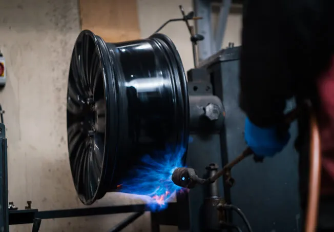 Alloy wheel being heated before being straightened