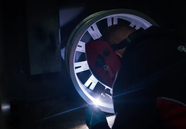 A cracked alloy being welded by a Rolling Rims employee