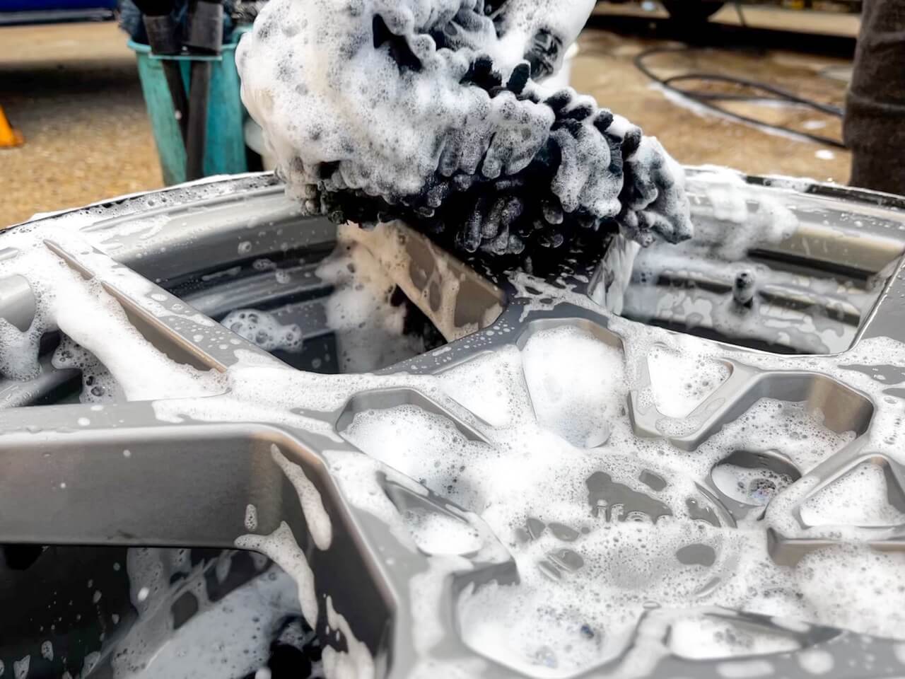 alloy wheel being washed with a soft microfiber