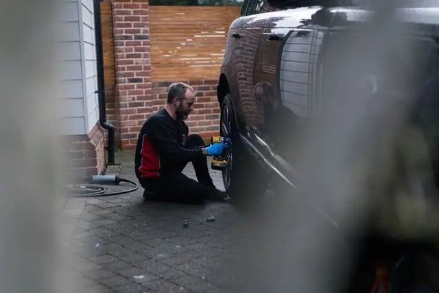 Rolling Rims employee removing an alloy wheel from a Range Rover ready for alloy wheel refurbishment