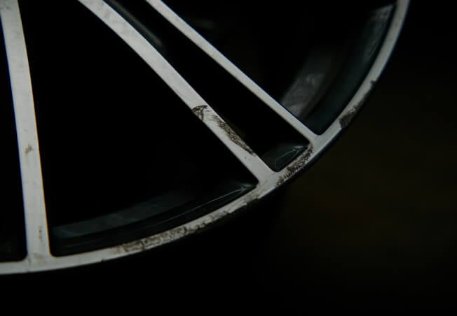 Damaged alloy wheel showing corrosion and cosmetic wear