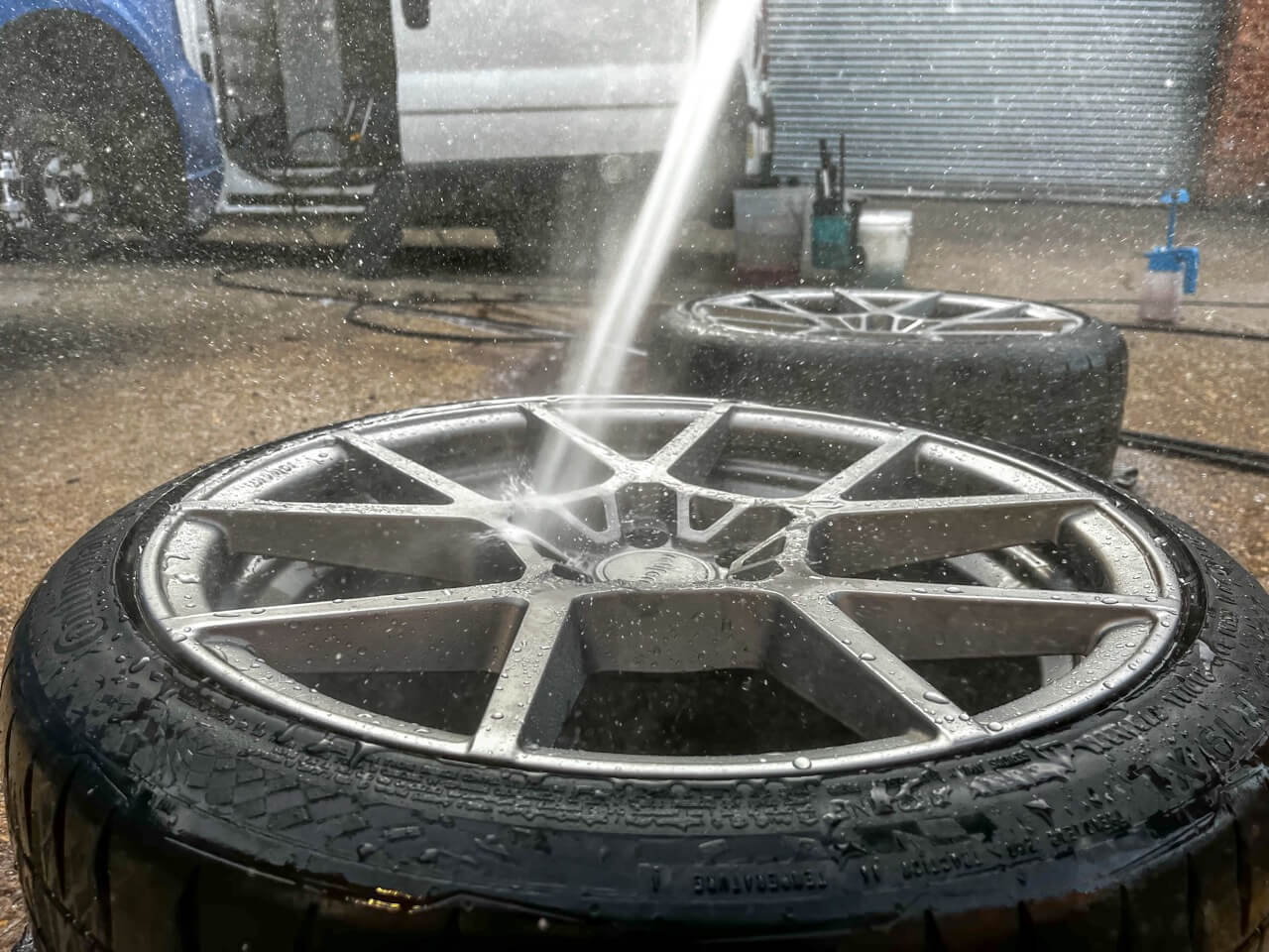 alloy wheels being sprayed with water to remove loose dirt