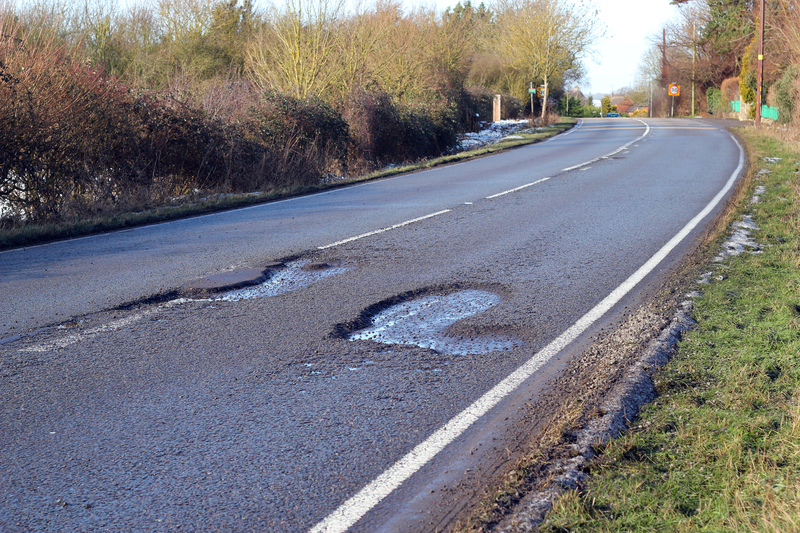 Pothole-ridden road in need of repair