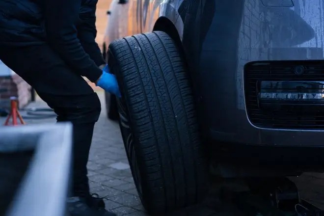 Rolling Rims employee removing an alloy wheel from a customers drive via the collection and delivery service