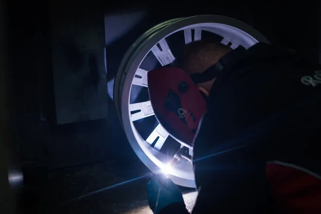 Cracked alloy wheel being welded by a Rolling Rims employee