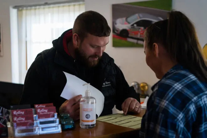 Rolling Rims employee explaining to the customer what needs attention before they return their lease car