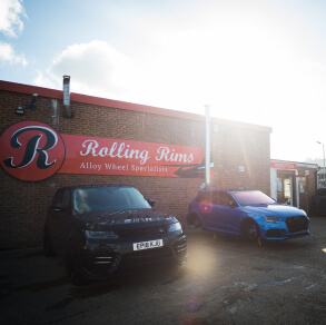 2 customer cars parked in front of Rolling Rims Dunmow workshop under the Rolling Rims sign